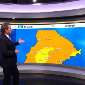 Meteorologist presenting local weather forecast in a studio setting