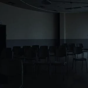 Somber prison visitation room reflecting an atmosphere of loss.