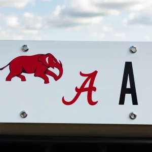 License plate design featuring the University of Alabama Vault A logo with an elephant and a crimson letter A.