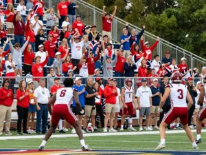 Exciting moment in an Alabama high school sports championship with enthusiastic crowds and athletes.