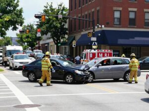 Scene of a car accident in Huntsville, Alabama, with emergency responders at the intersection.