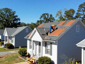 A worker repairing the roof of a house in West Alabama.