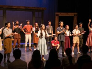 Community engagement at Theatre Tuscaloosa with diverse audiences enjoying a cultural performance.